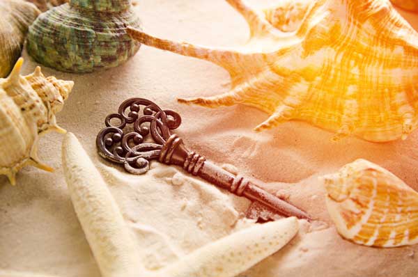 Lost treasure key on sand West Palm Beach Bankruptcy Lawyer